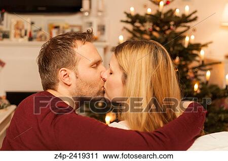 couple kissing on christmas eve. View Large Photo Image Stock Image - couple kissing on christmas eve.. Fotosearch