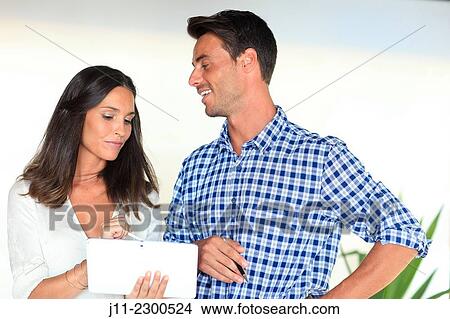 Couple with digital tablet View Large Photo Image Picture - Couple with digital tablet. Fotosearch