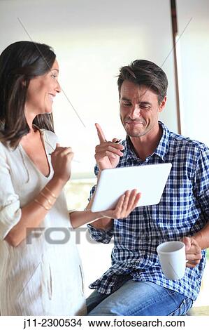 Couple with digital tablet View Large Photo Image Picture - Couple with digital tablet. Fotosearch