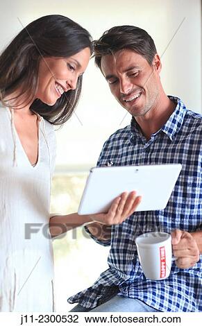Couple with digital tablet View Large Photo Image Stock Image - Couple with digital tablet. Fotosearch