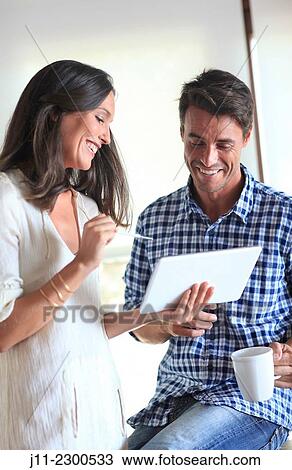 Couple with digital tablet View Large Photo Image Stock Image - Couple with digital tablet. Fotosearch