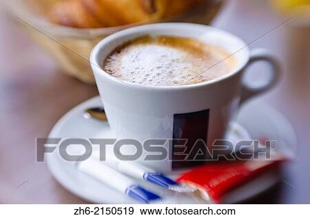Stock Photo - Cup of cafe au lait and croisants, Paris, France.. Fotosearch