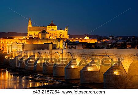 Córdoba´s Puente Romano, spanning the Guadalquivir river, and the Mezquita in the background. Illuminated at dusk. Córdoba, Córdoba province, Andalusia, Spain. View Large Photo Image Picture - Córdoba´s Puente Romano, spanning the Guadalquivir river, and the Mezquita in the background. Illuminated at dusk. Córdoba, Córdoba province, Andalusia, Spain.. Fotosearch