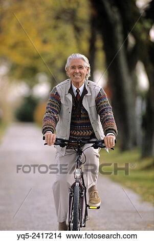 Picture - elderly man on bicycle... Fotosearch