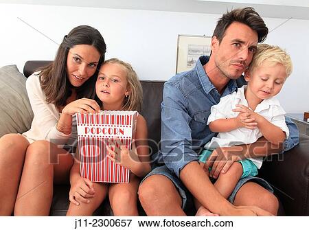 Family eating popcorn View Large Photo Image Stock Photo - Family eating popcorn. Fotosearch