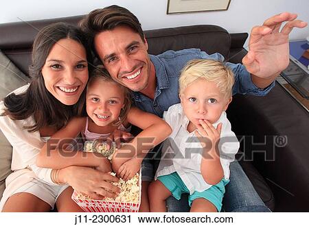 Stock Image - Family fun, eating popcorn. Fotosearch