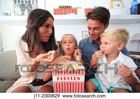 Family fun, eating popcorn View Large Photo Image Stock Photo - Family fun, eating popcorn. Fotosearch