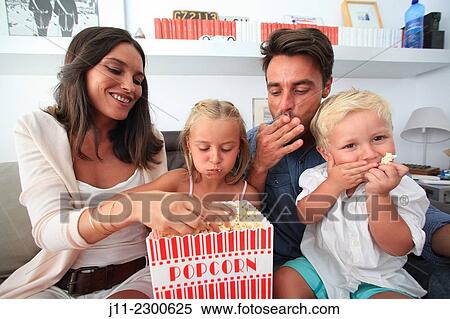 Stock Photography - Family fun, eating popcorn. Fotosearch