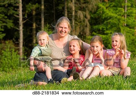 Picture - France, Bas Rhin, Urbeis near the Climont, family in a meadow.. Fotosearch