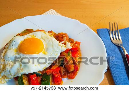 Fried egg on pisto manchego, close view. La Mancha, Spain. View Large Photo Image Stock Photo - Fried egg on pisto manchego, close view. La Mancha, Spain.. Fotosearch