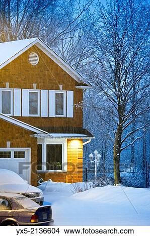Front yard of a two-storey house covered with snow in Toronto suburbs. View Large Photo Image Picture - Front yard of a two-storey house covered with snow in Toronto suburbs.. Fotosearch