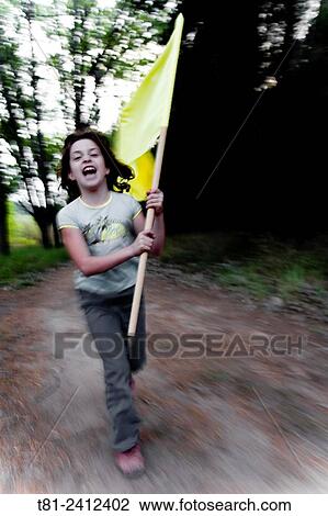 Stock Image - girl, flag running through the woods, Revolution, Chile. Fotosearch