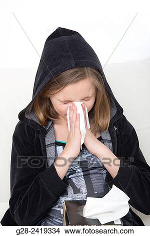 girl in a black hood, blowing her nose and sneezing View Large Photo Image Picture - girl in a black hood, blowing her nose and sneezing. Fotosearch