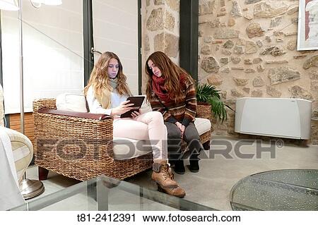 girls watching an ebook in the living room, Madrid, Spain View Large Photo Image Stock Image - girls watching an ebook in the living room, Madrid, Spain. Fotosearch