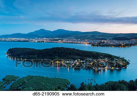 Greece, Epirus Region, Ioannina, elevated city view, Lake Pamvotis and Nisi Island, dusk. View Large Photo Image Stock Photography - Greece, Epirus Region, Ioannina, elevated city view, Lake Pamvotis and Nisi Island, dusk.. Fotosearch