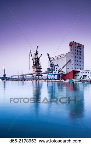 Greece, Thessaly Region, Pelion Peninsula, Volos, commercial port and cranes, dawn. View Large Photo Image Stock Image - Greece, Thessaly Region, Pelion Peninsula, Volos, commercial port and cranes, dawn.. Fotosearch