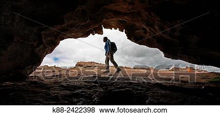 Hiker outside a cave in the northern Grampians. Victoria, Australia. View Large Photo Image Stock Photo - Hiker outside a cave in the northern Grampians. Victoria, Australia.. Fotosearch
