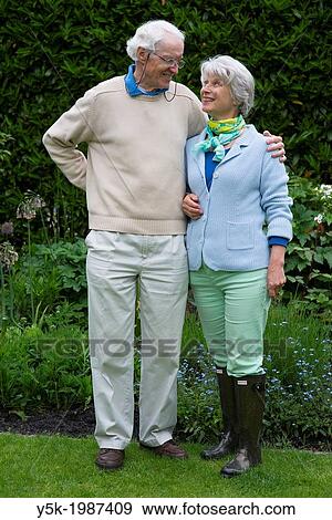 Stock Photo - Hilligersberg, Rotterdam, Netherlands. Elder, married couple, still in love, together in their green garden.. Fotosearch