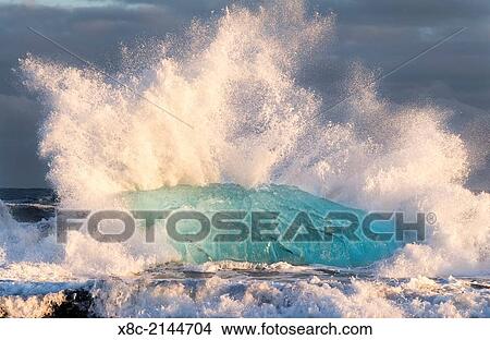 Picture - Iceberg on black vulcanic beach. North Atlantic beach of the ice lagoon Joekulsarlon at glacier Breithamerkurjoekull, Vatnajoekull NP. europe, northern europe, iceland, march.. Fotosearch