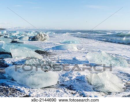 Iceberg on black vulcanic beach. North Atlantic beach of the ice lagoon Joekulsarlon at glacier Breithamerkurjoekull, Vatnajoekull NP. europe, northern europe, iceland, march. View Large Photo Image Stock Image - Iceberg on black vulcanic beach. North Atlantic beach of the ice lagoon Joekulsarlon at glacier Breithamerkurjoekull, Vatnajoekull NP. europe, northern europe, iceland, march.. Fotosearch