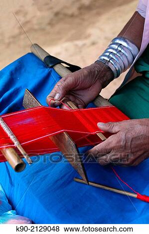 Longneck Karen woman weaving a red scarf, Mae Hong Son, Thailand, Southeast Asia. View Large Photo Image Stock Photo - Longneck Karen woman weaving a red scarf, Mae Hong Son, Thailand, Southeast Asia.. Fotosearch
