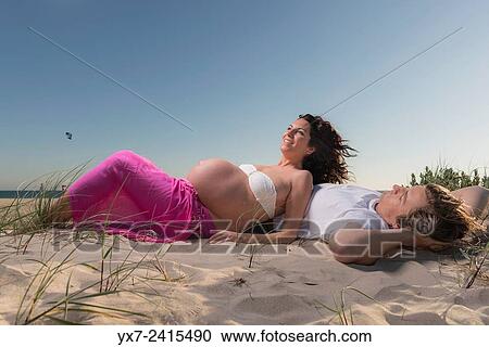 Man and pregnant woman at the beach. Tarifa, Costa de la Luz, Cadiz, Andalusia, Spain, Europe. View Large Photo Image Stock Image - Man and pregnant woman at the beach. Tarifa, Costa de la Luz, Cadiz, Andalusia, Spain, Europe.. Fotosearch