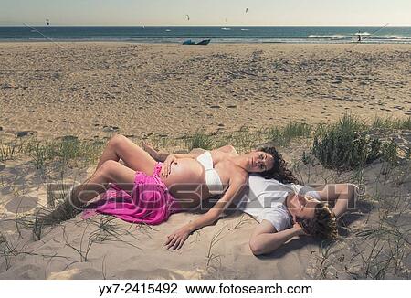 Stock Image - Man and pregnant woman at the beach. Tarifa, Costa de la Luz, Cadiz, Andalusia, Spain, Europe.. Fotosearch