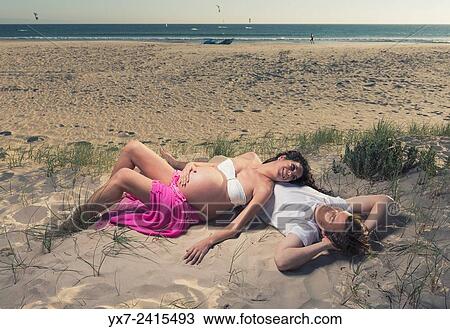Man and pregnant woman at the beach. Tarifa, Costa de la Luz, Cadiz, Andalusia, Spain, Europe. View Large Photo Image Stock Image - Man and pregnant woman at the beach. Tarifa, Costa de la Luz, Cadiz, Andalusia, Spain, Europe.. Fotosearch