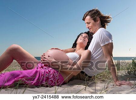 Man and pregnant woman at the beach. Tarifa, Costa de la Luz, Cadiz, Andalusia, Spain, Europe. View Large Photo Image Stock Photo - Man and pregnant woman at the beach. Tarifa, Costa de la Luz, Cadiz, Andalusia, Spain, Europe.. Fotosearch