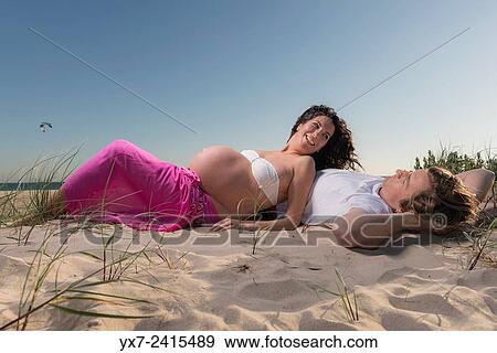 Stock Photo - Man and pregnant woman at the beach. Tarifa, Costa de la Luz, Cadiz, Andalusia, Spain, Europe.. Fotosearch
