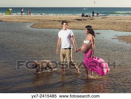 Man and pregnant woman at the beach. Tarifa, Costa de la Luz, Cadiz, Andalusia, Spain, Europe. View Large Photo Image Stock Photography - Man and pregnant woman at the beach. Tarifa, Costa de la Luz, Cadiz, Andalusia, Spain, Europe.. Fotosearch