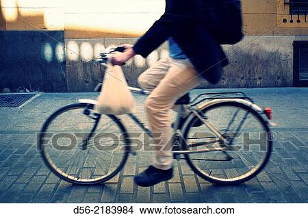 man carrying a plastic bag on a bicycle, Cavallers street, Valencia, Spain. View Large Photo Image Picture - man carrying a plastic bag on a bicycle, Cavallers street, Valencia, Spain.. Fotosearch