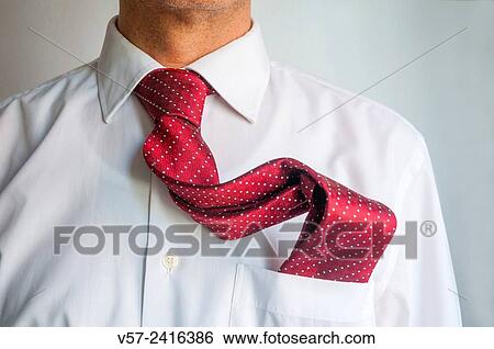 Stock Photograph - Man with his tie into the pocket of his shirt. Close view.. Fotosearch