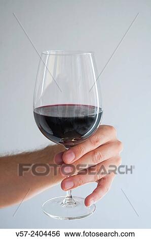 Man´s hand holding a glass of red wine. Close view. View Large Photo Image Stock Photograph - Man´s hand holding a glass of red wine. Close view.. Fotosearch