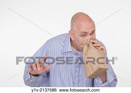 Middle-age bald man blowing into a paper bag. View Large Photo Image Stock Photograph - Middle-age bald man blowing into a paper bag.. Fotosearch