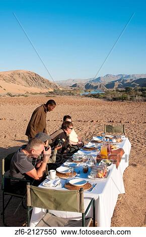 Namibia Africa Northern Desert of Namib Desert border of Angola and Kunene River safari with lunch on river with tent and campers in Hartmann Berge deserted land Hartmann Valley Marienflub, Serra Cafema Resort. View Large Photo Image Stock Image - Namibia Africa Northern Desert of Namib Desert border of Angola and Kunene River safari with lunch on river with tent and campers in Hartmann Berge deserted land Hartmann Valley Marienflub, Serra Cafema Resort.. Fotosearch