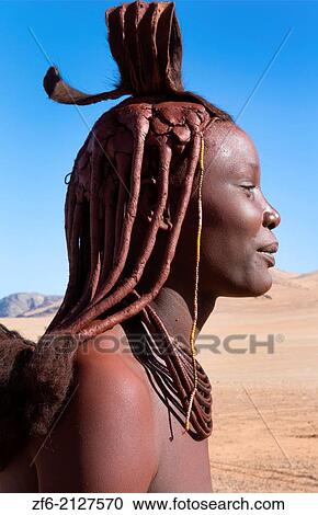 Namibia Africa remote nomadic Himba tribe young woman portrait in desert with traditional dress in desert of Hartmann Berge in Namib Desert t black girl. View Large Photo Image Stock Image - Namibia Africa remote nomadic Himba tribe young woman portrait in desert with traditional dress in desert of Hartmann Berge in Namib Desert t black girl.. Fotosearch