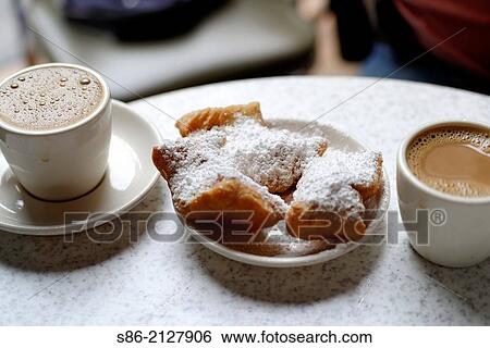 New Orleans Beignet Fried Pastries and Two Cups of Cafe Au Lait, Served at a Cafe. View Large Photo Image Stock Photograph - New Orleans Beignet Fried Pastries and Two Cups of Cafe Au Lait, Served at a Cafe.. Fotosearch