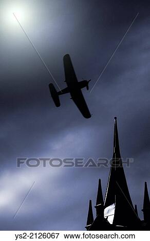 Old propeller fighter plane flying on a moonlit sky over building rooftop. View Large Photo Image Stock Photo - Old propeller fighter plane flying on a moonlit sky over building rooftop.. Fotosearch