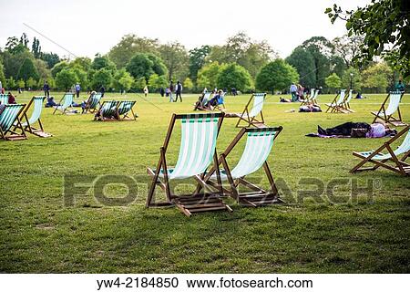 People sitting on deck chairs, Hyde Park, London, UK. View Large Photo Image Stock Image - People sitting on deck chairs, Hyde Park, London, UK.. Fotosearch