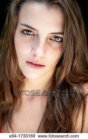 Portrait of a serious 20 year old brunette woman looking directly at the camera. View Large Photo Image Stock Photo - Portrait of a serious 20 year old brunette woman looking directly at the camera.. Fotosearch