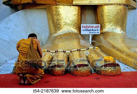 Praying monk at Wat Intharawihan in Bangkok View Large Photo Image Stock Photo - Praying monk at Wat Intharawihan in Bangkok. Fotosearch