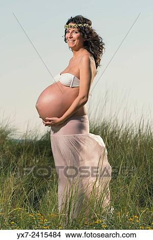 Picture - Pregnant woman at the beach. Tarifa, Costa de la Luz, Cadiz, Andalusia, Spain, Europe.. Fotosearch