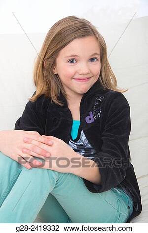 pretty girl smiling and looking happy, looking at camera, sitting indoor View Large Photo Image Stock Image - pretty girl smiling and looking happy, looking at camera, sitting indoor. Fotosearch