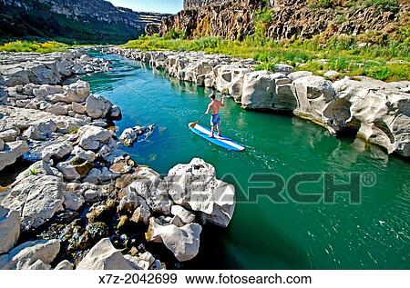 Riding the Stand Up Paddle Board on the Snake River above Twin Falls and the Idaho Connection Wave in the Snake River Canyon near the city of Twin Falls in southern Idaho. View Large Photo Image Stock Photo - Riding the Stand Up Paddle Board on the Snake River above Twin Falls and the Idaho Connection Wave in the Snake River Canyon near the city of Twin Falls in southern Idaho.. Fotosearch