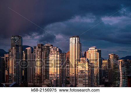 Stock Photography - skyline condo towers at sunset on the north shore of False Creek, Vancouver, BC, Canada.. Fotosearch