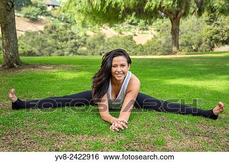 Smiling woman performing a full split in Balboa Park, San Diego, California. View Large Photo Image Stock Photograph - Smiling woman performing a full split in Balboa Park, San Diego, California.. Fotosearch