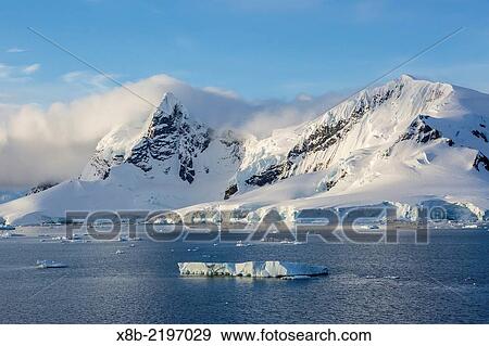 Snow-capped mountains of Cuverville Island, Errera Channel, Antarctica. View Large Photo Image Stock Photo - Snow-capped mountains of Cuverville Island, Errera Channel, Antarctica.. Fotosearch