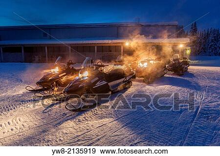Stock Photo - Snowmobiles in the freezing cold temperatures as low as -47 celsius. Lapland, Sweden.. Fotosearch