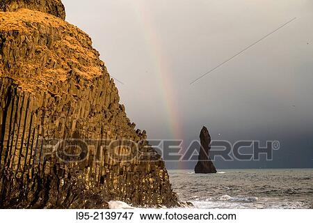 Solidified lava rocks named as Trolls after the local mythology located near Vik, Iceland. View Large Photo Image Stock Photo - Solidified lava rocks named as Trolls after the local mythology located near Vik, Iceland.. Fotosearch